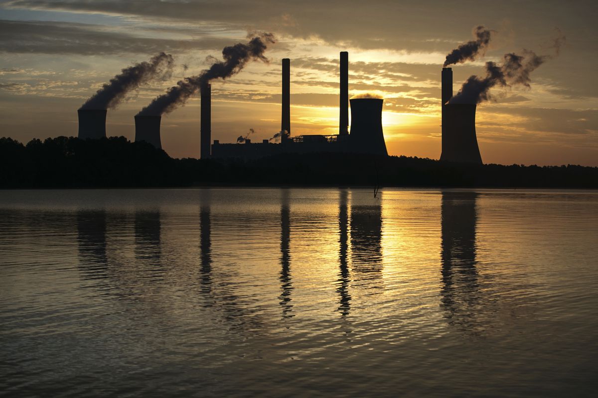 The coal-fired Plant Scherer, one of the nation’s top carbon dioxide emitters, stands in 2017 in the distance in Juliette, Ga. President Joe Biden will pledge to cut U.S. greenhouse gas emissions at least in half by 2030 as he convenes a virtual climate summit.  (Associated Press)
