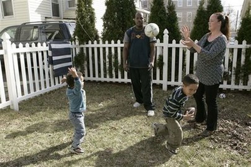 In this March 30, 2007 photo, Michelle, right, and James Cadeau play ball with their children, Elliot, 2, left, and Justin, 5, in the backyard of their home in West Orange, N.J.. The surge of interracial marriages and multiracial children is producing a 21st century America more diverse than ever, with the potential to become less stratified by race.
(AP Photo/Mike Derer) (Mike Derer / Associated Press)