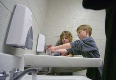 Tiras Wilbur, left,  and Marcus Holland  wash their hands after coming in from the playground Friday at Audubon Elementary School. Recent reports of MRSA cases in schools across Washington state have sparked sanitizing efforts.   
 (CHRISTOPHER ANDERSON / The Spokesman-Review)