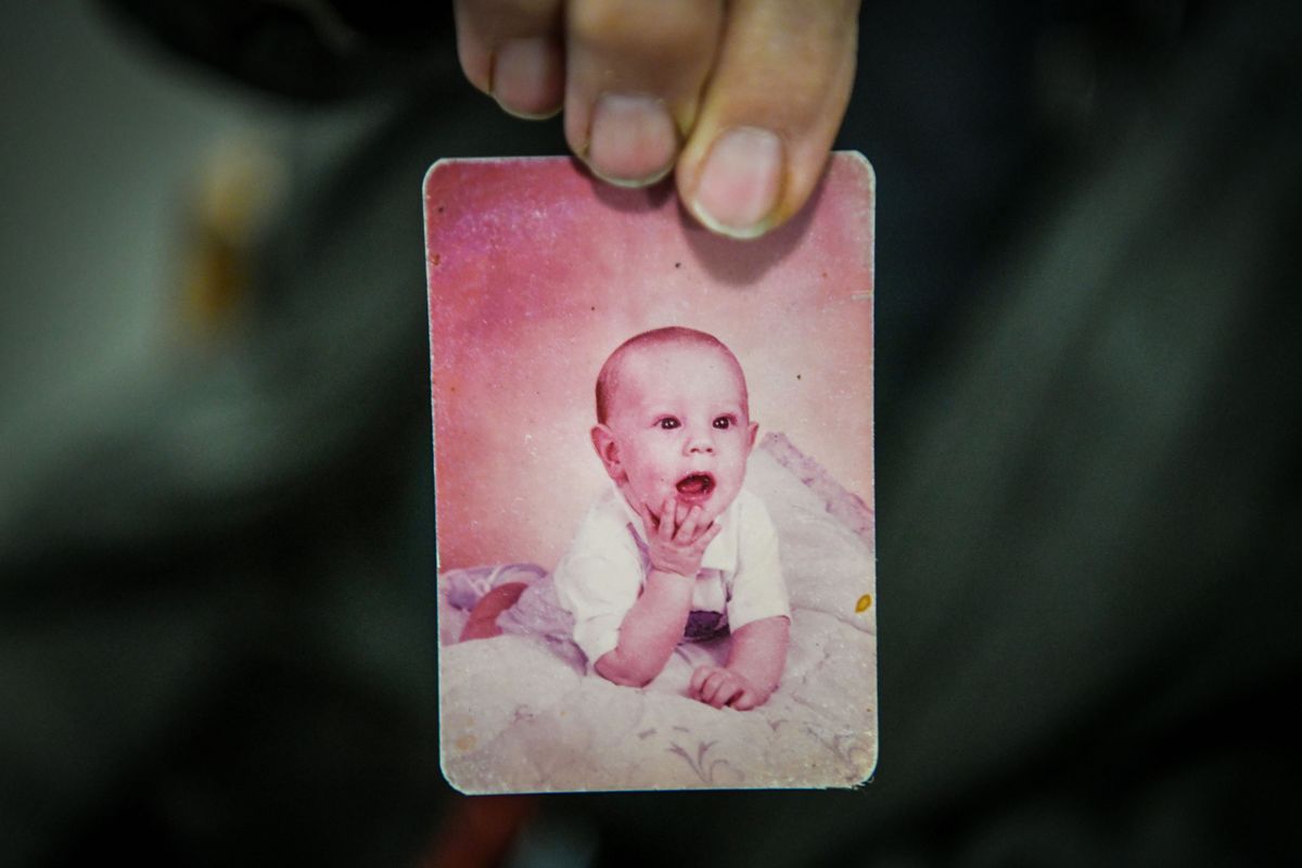 Shirley DePew holds a picture of her son, James Peterson, as a toddler as she awaits the sentencing of Robert Tolliver.  (DAN PELLE/THE SPOKESMAN-REVIEW)
