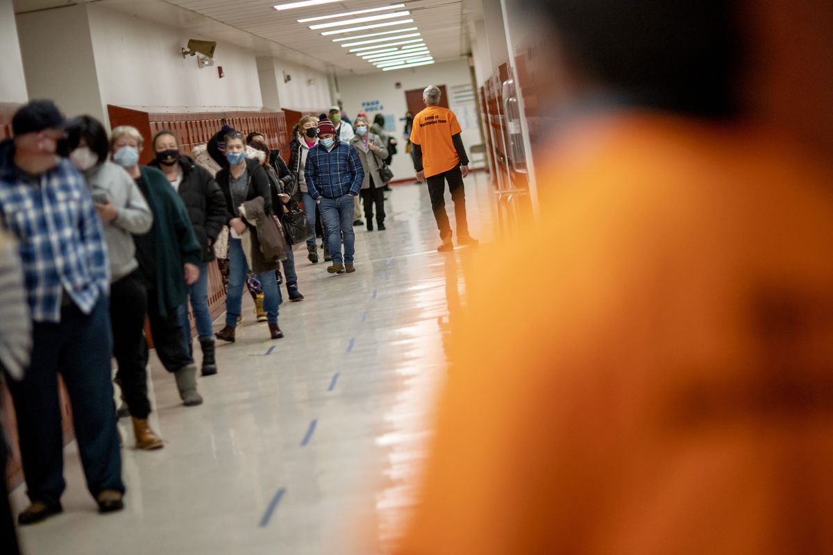 People line up for vaccines at a clinic in Central Falls, R.I., on Saturday.  (David Goldman)
