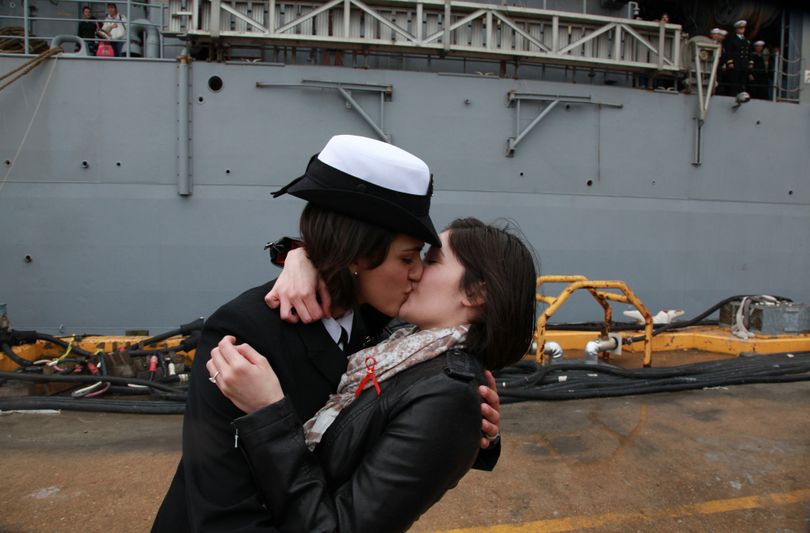 Petty Officer 2nd Class Marissa Gaeta, left, kisses her partner, Petty Officer 3rd Class Citlalic Snell, at Joint Expeditionary Base Little Creek-Fort Story in Virginia Beach, Va. (Associated Press)