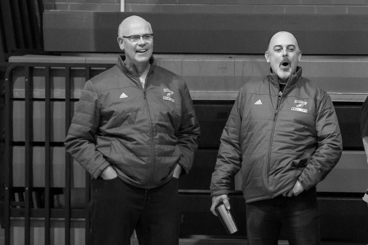 Ron Cox, left, and Jamie Cox take in practice at Lakeside HS in an undated family photo.  (Courtesy)