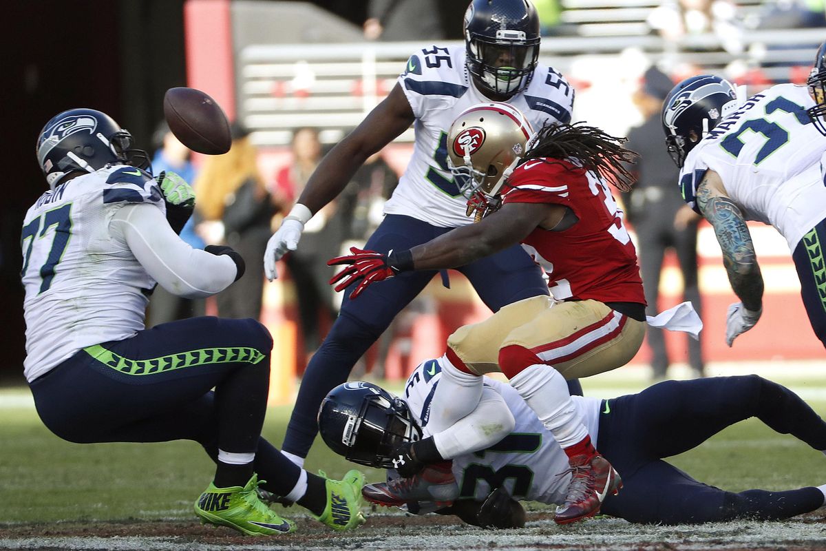 San Francisco 49ers running back DuJuan Harris, center, fumbles the football against the Seattle Seahawks during the first half of an NFL football game in Santa Clara, Calif., Sunday, Jan. 1, 2017. Seattle recovered the ball. (Tony Avelar / Associated Press)