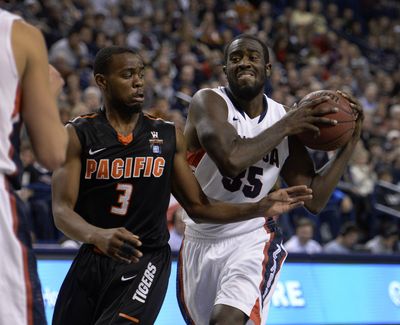 Bulldogs’ Sam Dower snatches rebound away from Tigers’ Sama Taku during second-half action on Saturday. (Colin Mulvany)
