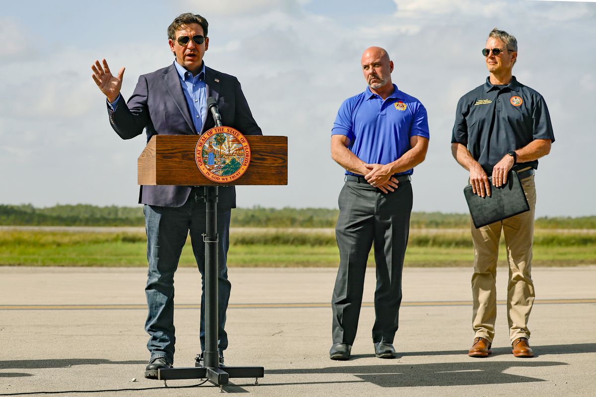Governor Ron DeSantis speaks to reporters during a press conference on the airplane runway of Alligator Alcatraz in Ochopee, Florida on Friday, July 25, 2025. Next to the governor is Florida Department of Financial Services Chief Financial Officer Blaise Ingoglia and Florida State Board of Immigration Enforcement Executive Director Larry Keefe. (Al Diaz/Miami Herald/TNS) (Al Diaz/Miami Herald/TNS)