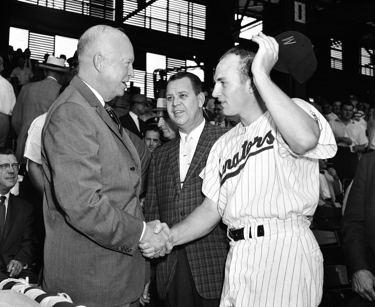 FILE - This May 29, 1959, file photo shows Harmon Killebrew, of the Washington Senators, , shaking hands with President Dwight D. Eisenhower before the start of  a baseball game against Boston, in Washington. At center is Calvin Griffith, president of the Senators. Hall of Famer Killebrew, known for his tape-measure home runs, died Tuesday, May 17, 2011, at his home in Scottsdale, Ariz. He was 74. (Harvey Georges / Associated Press)