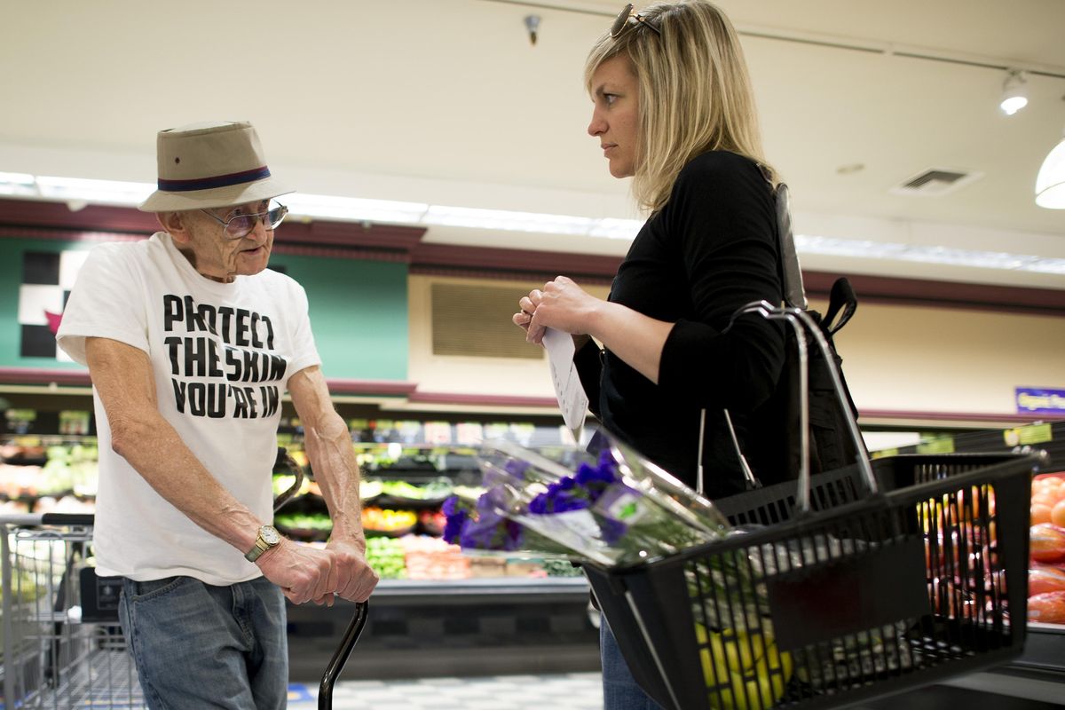 Gerald Ray talks to Rosauers customer Julie Koesel about the dangers of skin cancer. Ray, a retired educator, crusades against skin cancer by handing out awareness information at local stores, churches and pharmacies. (Colin Mulvany / The Spokesman-Review)