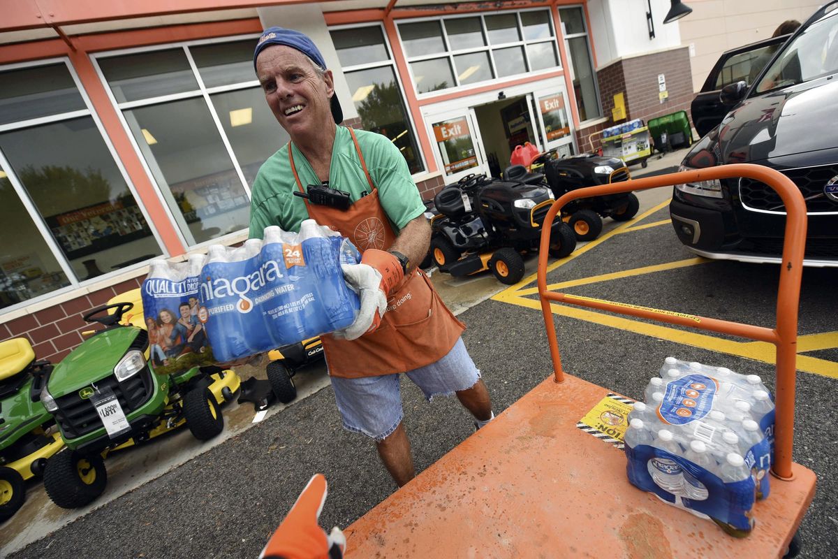 Chris Rayner helps customers load their cars as they buy supplies at The Home Depot on Monday, Sept. 10, 2018, in Wilmington, N.C. Hurricane Florence rapidly strengthened into a potentially catastrophic hurricane on Monday as it closed in on North and South Carolina, carrying winds and water that could wreak havoc over a wide stretch of the eastern United States later this week. (Ken Blevins/The Star-News / Associated Press)