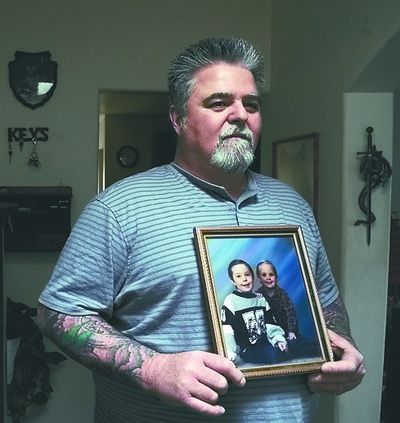 Bill Connington holds a portrait of his boys that he has kept in his house since his ex-wife took  them from the area in 1998.  (File)