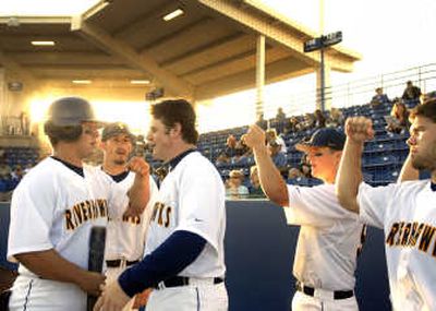 
The Spokane RiverHawks celebrate during their four-run first inning Thursday, getting their 2007 season off to a fast start. 
 (Jed Conklin / The Spokesman-Review)