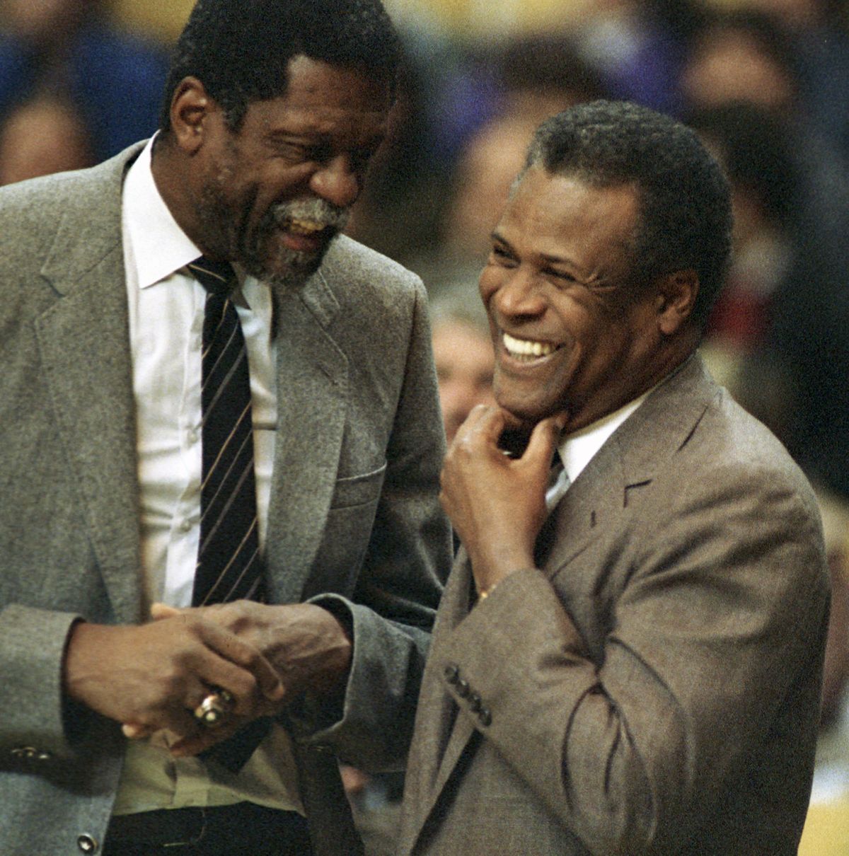 Former Boston Celtics teammates Bill Russell, left, and K.C. Jones meet before the start of an NBA game in January 1988 at the Boston Garden.  (Associated Press)