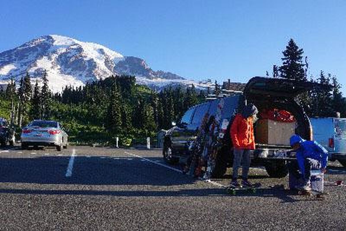 Owen and Maks Page gear up at the Paradise lot to hike in for August skiing at Mount Rainier National Park. (TR PAGE PHOTO)