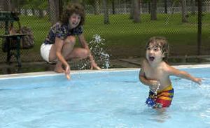 
Hendrix Cronin, 2, looks toward his dad, Jim (not pictured), as family friend LuAnne Swainson splashes him at the Comstock Park wading pool  Thursday. All Spokane wading pools will close Sunday. The six outdoor pools will close today.
 (Kathryn Stevens / The Spokesman-Review)