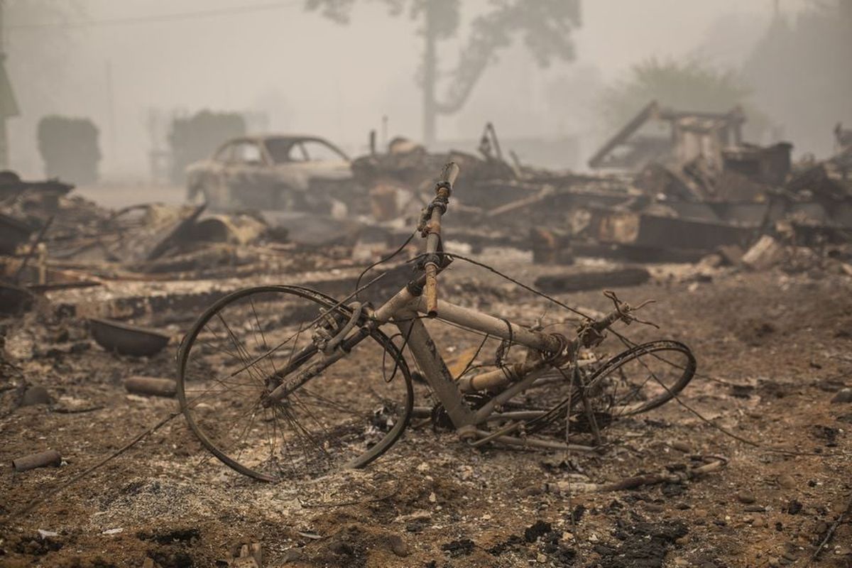 A bicycle sits outside the remains of a burned home in Gates, Ore., on Sept. 13, 2020. The town of Gates, along the Santiam River was all but destroyed by fire that ignited Labor Day 2020.  (Brooke Herbert/The Oregonian)