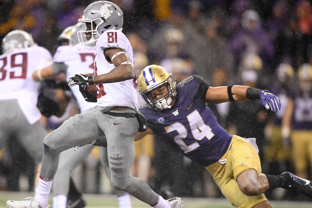 Washington State Cougars wide receiver Renard Bell  runs the ball against Washington Huskies defensive back Ezekiel Turner  during the second half of the 2017 Apple Cup,  Nov. 23 at Husky Stadium in Seattle. (Tyler Tjomsland / The Spokesman-Review)