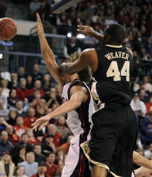 Gonzaga's Matt Bouldin takes a shot to the chops from Wake Forest's David Weaver in the second half. (Dan Pelle / The Spokesman-Review)