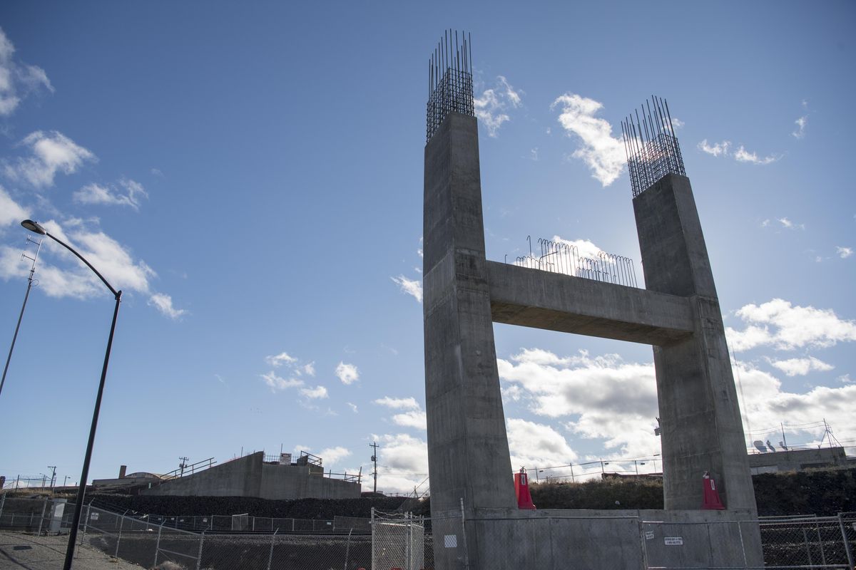 The support arch, right, for the new University District pedestrian bridge is up to 40 feet in height as construction is tapered off for the season, shown Tuesday, Nov. 14, 2017. The south side ramp structure is shown at left. The bridge, which will be finished next summer, will span the railroad tracks that span the downtown. Jesse Tinsley/THE SPOKESMAN-REVIEW (Jesse Tinsley / The Spokesman-Review)