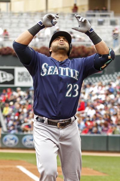 Mariners designated hitter Nelson Cruz celebrates his home run against the Minnesota Twins in the second inning of Sunday’s game in Minneapolis. (Bruce Kluckhohn / Associated Press)