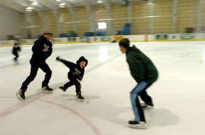 Marcel Epkey, 6, center, chases his brother Nate, 15, at the KYRO Ice Arena in Coeur d'Alene, followed by their father, Charlie Epkey.
(Jesse Tinsley / The Spokesman-Review)