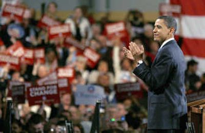 
Democratic presidential hopeful Sen. Barack Obama, D-Ill., applauds supporters at a rally at the Hy Vee Center in Des Moines, Iowa, after winning the  state's Democratic presidential caucus Thursday.
 (Associated Press / The Spokesman-Review)