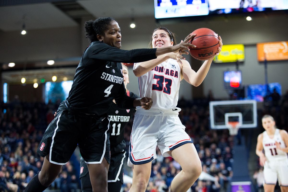 Melody Kempton (33) tries to maintain possession while Nadia Fingall (4) of Stanford tries to gain it at the McCarthey Athletic Center on Sunday, Dec. 2, 2018. The Zags beat Stanford 79-73 in a close battle. (Libby Kamrowski / The Spokesman-Review)