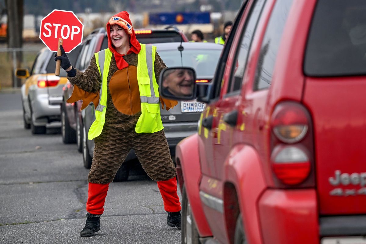 Starbucks volunteer Shannon Metcalf dressed in her turkey suit dances for the crowd Tuesday during Tom’s Turkey Drive at the Spokane County Interstate Fairgrounds.  (Kathy Plonka/The Spokesman-Review)