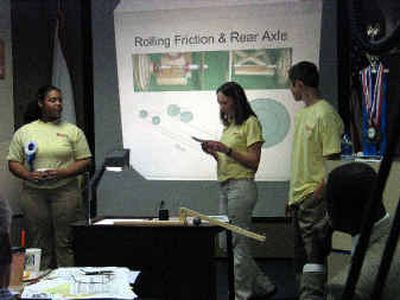 
From left, DeAndra Kenoly of North Central, Jennifer McGlothen, Lewis and Clark, and D.J. May, NC, present their design of a mousetrap-powered multipurpose vehicle at a Washington MESA Board meeting. The design took second place at the National Engineering Design Competition in June. 
 (Kandis Carper / The Spokesman-Review)