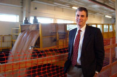 
 Peter Goodwin, director of UI's Center for Ecohydraulics Research, stands in front of the new flume. At 60 feet long, the flume allows scientists to simulate water, gravel and sediment flows in varying stream conditions. 