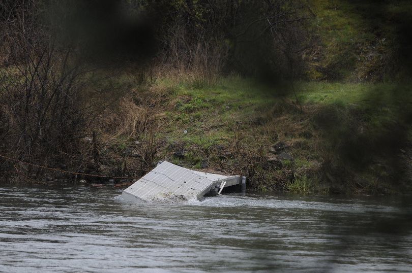 Both docks in the Coyote Rocks development in the Spokane Valley have been damaged this spring from the rising waters of the Spokane River.  (J. Bart Rayniak)