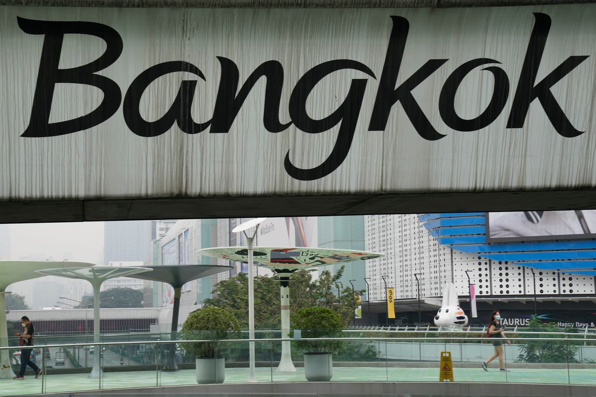 Peoples walk on the elevated pathway under the "Bangkok" signage written on the sky train track in Bangkok, Thailand, Thursday, Feb. 17, 2022. After some confusions, the Royal Society issued a clarification explaining: “Writing the capital city’s official name with the Roman alphabet can be done both as Krung Thep Maha Nakon and Bangkok.” (Sakchai Lalit)