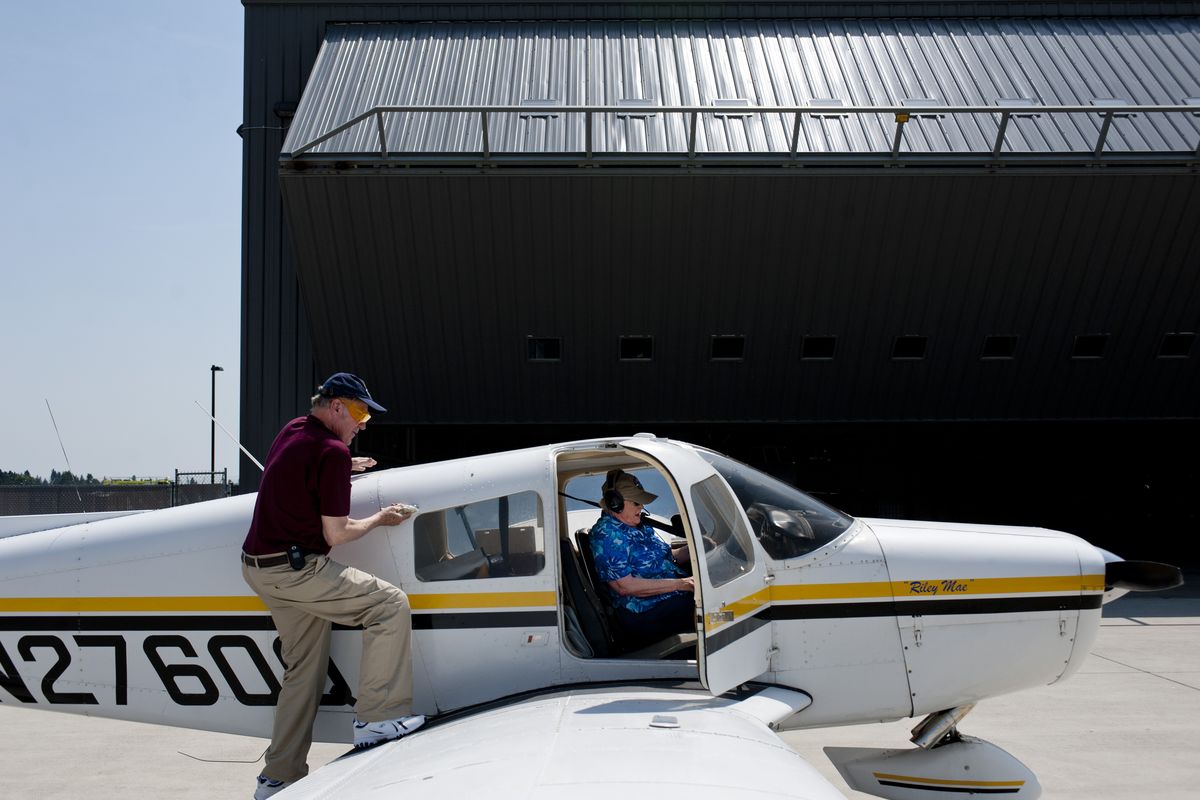 Lew Wetzel climbs aboard as Ann Orton goes through a preflight checklist before leaving Spokane International Airport on Thursday after a United Flying Octogenarians meeting. Orton, now 81, became a pilot at age 78. “I love flying to see my children,” she said. (Tyler Tjomsland)