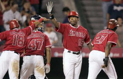 Garret Anderson of the Angels is congratulated at home plate after a grand slam. Associated Press
 (Associated Press / The Spokesman-Review)