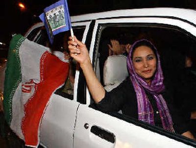 
An Iranian woman joins massive street celebrations after Iran qualified for the 2006 World Cup finals by beating visiting Bahrain 1-0 in an Asian qualifying match in Tehran, Iran, on Wednesday. 
 (Associated Press / The Spokesman-Review)
