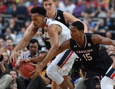 Gonzaga forward Johnathan Williams (3) and South Carolina guard PJ Dozier (15) compete for a loose ball during the second half of an NCAA Final Four basketball game, Sat., April 1, 2017, in Phoenix. (Colin Mulvany / The Spokesman-Review)