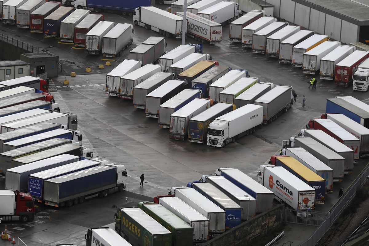 Trucks are parked in Dover, whilst the Port remains closed, in Kent, England, Tuesday, Dec. 22, 2020. Trucks waiting to get out of Britain backed up for miles and people were left stranded at airports as dozens of countries around the world slapped tough travel restrictions on the U.K. because of a new and seemingly more contagious strain of the coronavirus in England.  (Kirsty Wigglesworth)
