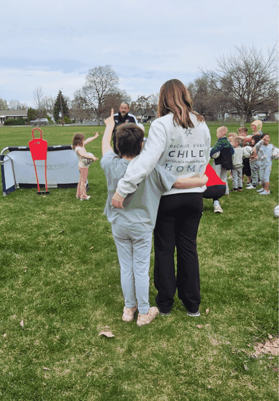 A Family Promise volunteer hugs a child during a soccer activity.  (Courtesy)