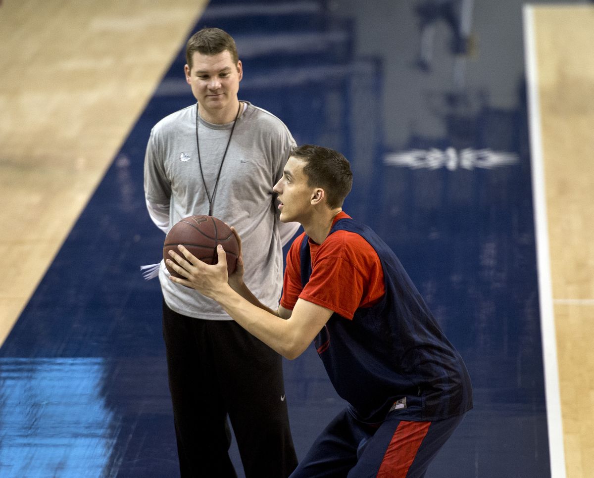 Gonzaga's Kyle Dranginis takes shooting instruction from coach Tommy Lloyd before practice on Monday. (Dan Pelle)