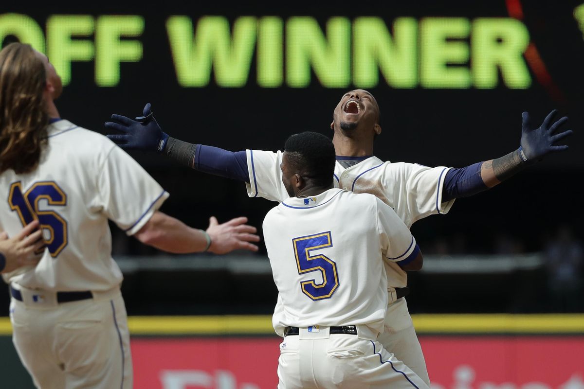 Seattle Mariners’ Jean Segura, right, celebrates with Guillermo Heredia (5) after hitting a walkoff RBI-single to score Dee Gordon and give them a victory over the Detroit Tigers in the 11th inning of a baseball game Sunday, May 20, 2018, in Seattle. (Ted S. Warren / Associated Press)