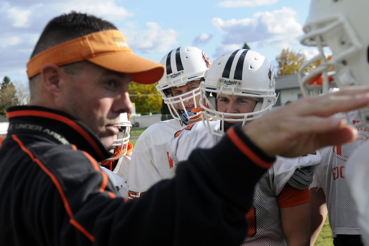 West Valley running back Dylan Ellsworth (front center) listens closely as coach Craig Whitney explains the nontraditional condition drills the team will do Monday.