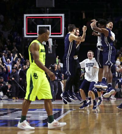 The Yale Bulldogs jump for joy after upsetting the Baylor Bears for the university’s first NCAA tournament victory. (Associated Press)