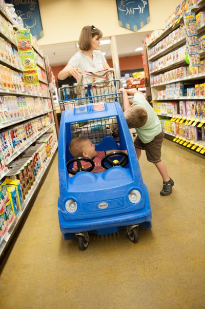 }Hyrum and Emmett Ditto “help” their mom shop during a trip to the grocery store in 2016.  (Michelle Giles)