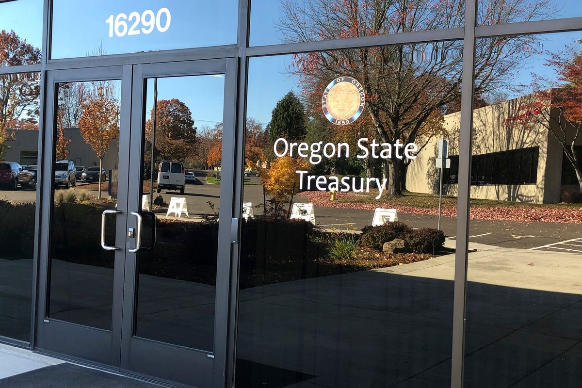 FILE - Nearby buildings are reflected in the windows of the Oregon State Treasury office in Tigard, Ore., on Oct. 30, 2019. A spokeswoman for Oregon State Treasurer Tobias Read said Thursday, Dec. 16, 2021, that Read is looking for clarity in the murky situation surrounding a 2017 investment by the state in a private equity fund called Novalpina Capital, which later acquired a majority share of NSO Group, an Israeli company that produces smartphone spyware and has been blacklisted by the U.S. government.  (Andrew Selsky)