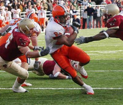 
Syracuse's Diamond Ferri, center, heads for a touchdown against Boston College's Brian Toal, left, and Jazzmen Williams.
 (Associated Press / The Spokesman-Review)