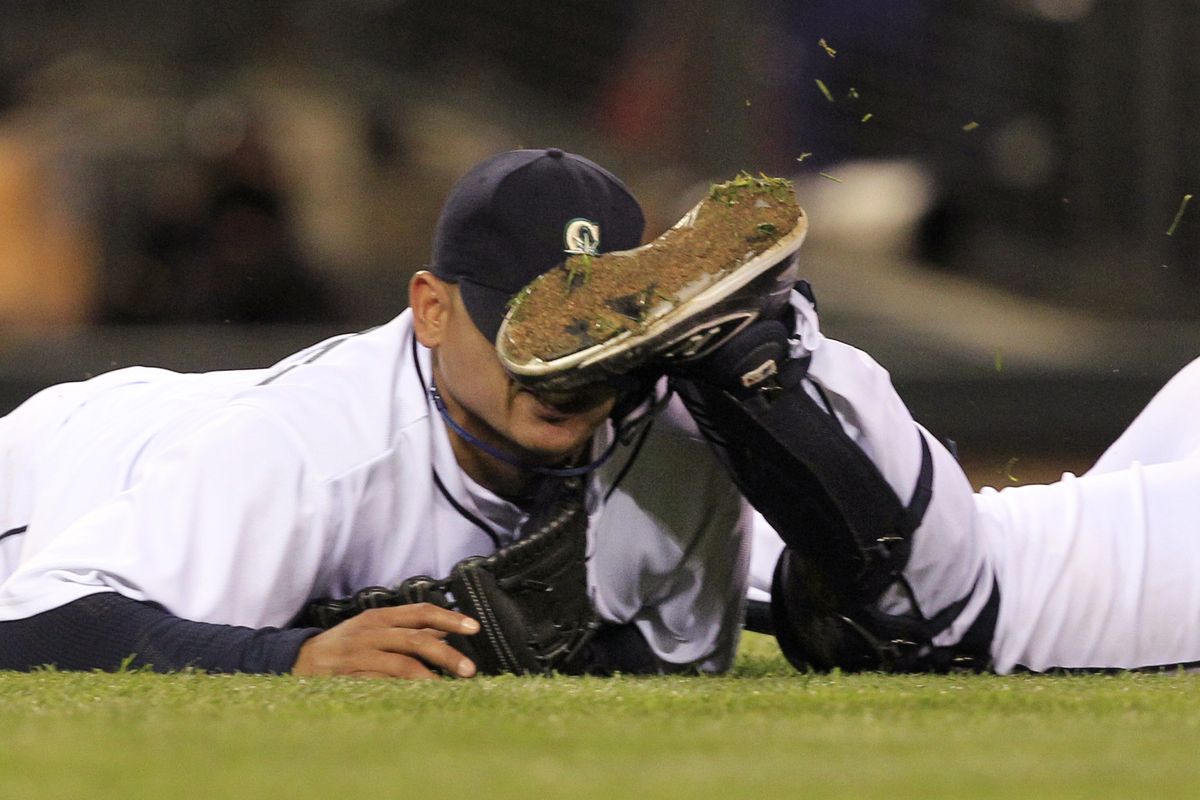 Mariners starting pitcher Felix Hernandez is kicked in the head by catcher Rob Johnson after the two chased a bunt from Baltimore’s Cesar Izturis in the fifth inning. Hernandez finished the game.   (Associated Press)