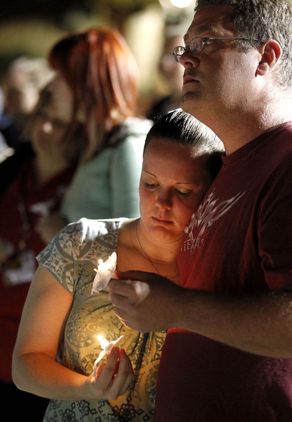 People gather in Centennial Plaza in Midland, Texas on Saturday, Nov. 17, 2012 for a candlelight vigil held in honor of four veterans who were killed when a freight train hit a parade float Thursday. (James Durbin / Midland Reporter-telegram)
