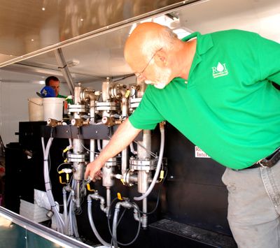 Renewable Oil International’s Phillip Badger explains Wednesday how his portable fast pyrolysis unit works.  (Associated Press / The Spokesman-Review)