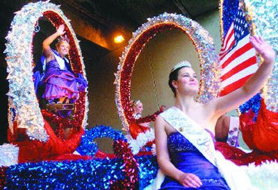 
Lilac Queen Wylie Patton, left, of Freeman High School, and Princess Margeaux Fox, of Lewis and Clark High School, wave at the start of the 2007 Lilac Festival Armed Forces Torchlight Parade on Saturday. This year's theme was Here's to the Heroes. 
 (Ingrid Lindemann / The Spokesman-Review)