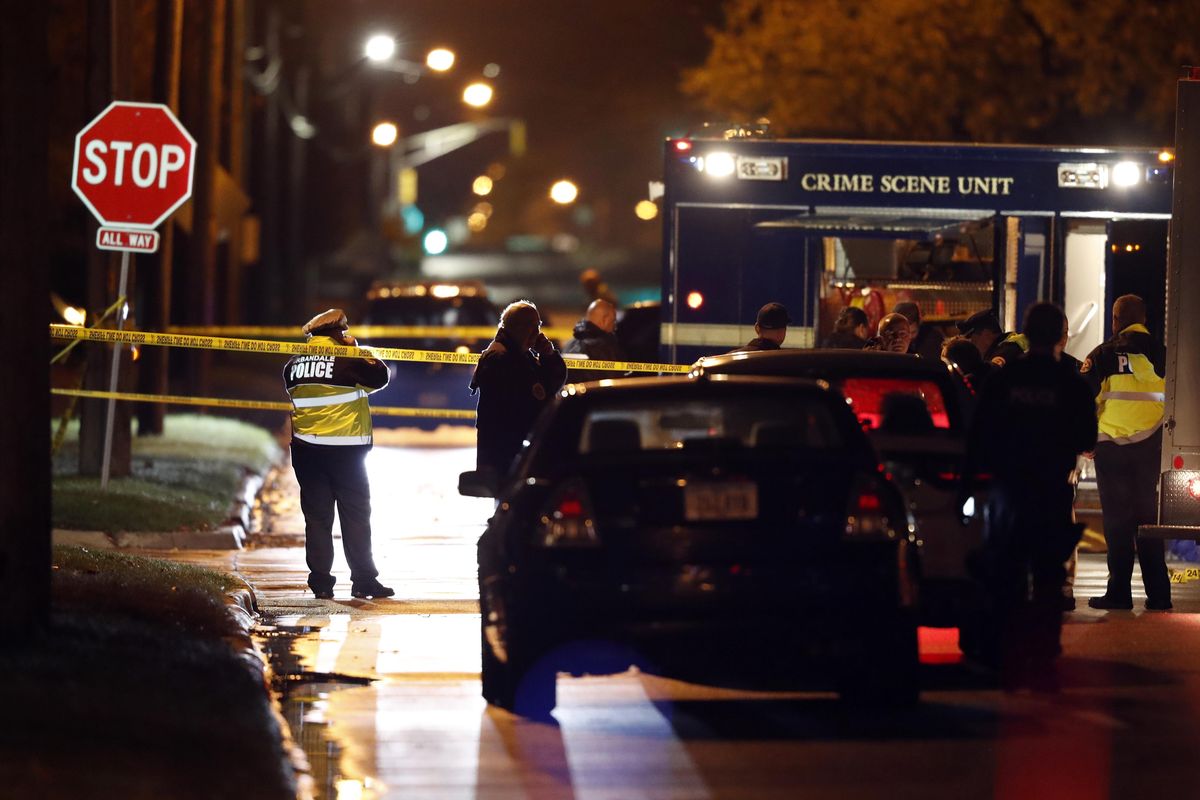 Law enforcement officials investigate at the scene of a shooting, Wednesday, Nov. 2, 2016, in Urbandale, Iowa. Two Des Moines area police officers were shot to death early Wednesday in ambush-style attacks while they were sitting in their patrol cars. (Charlie Neibergall / AP)