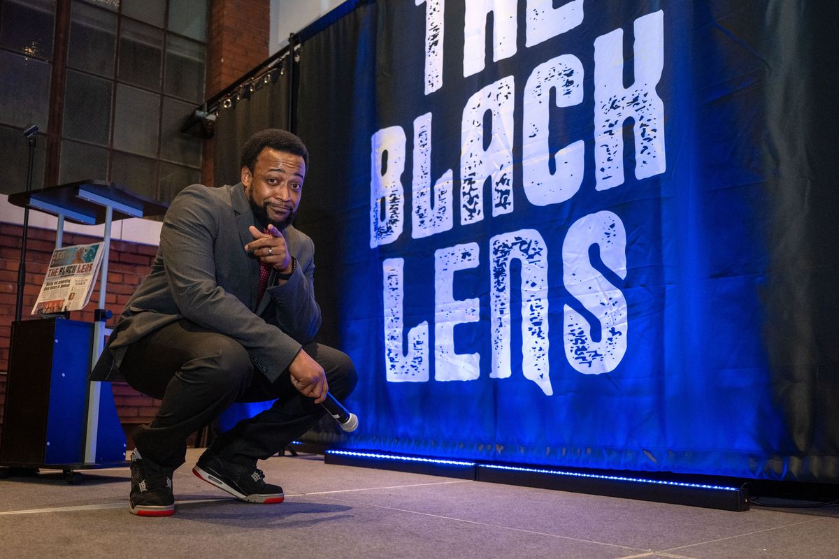 Master of ceremonies for the night and The Black Lens board member Michael Bethely strikes a pose on stage before speaking to the large crowd gathered at the relaunch party for The Black Lens newspaper on Feb. 2 at the Steam Plant rooftop event center.  (COLIN MULVANY/THE SPOKESMAN-REVIEW)